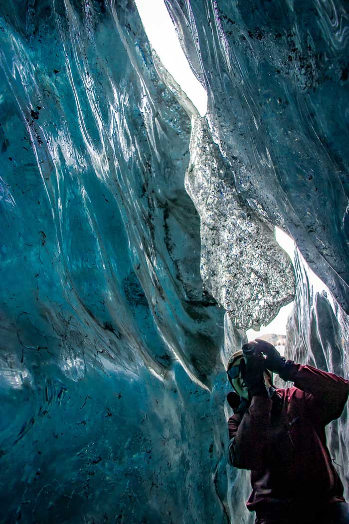 Touring the inside of blue ice glacier crevasse ice cave during a guided glacier tour near Anchorage, Alaska with Glacier Tours on the Matanuska Glacier.